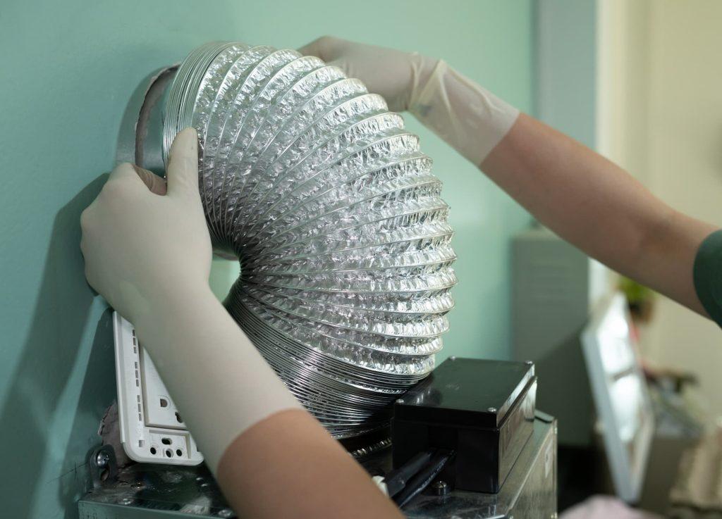 Person installing flexible ducting